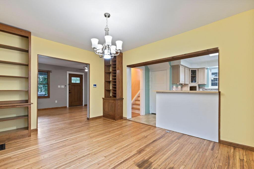 222 Brighton Road Columbus, OH 43202 - Photo 10 of 46 • Re-finished hardwood flooring 2023 •Chandelier lighting • 2 Built-in Shelves • Custard painted walls • Opens to Kitchen & 3-season room