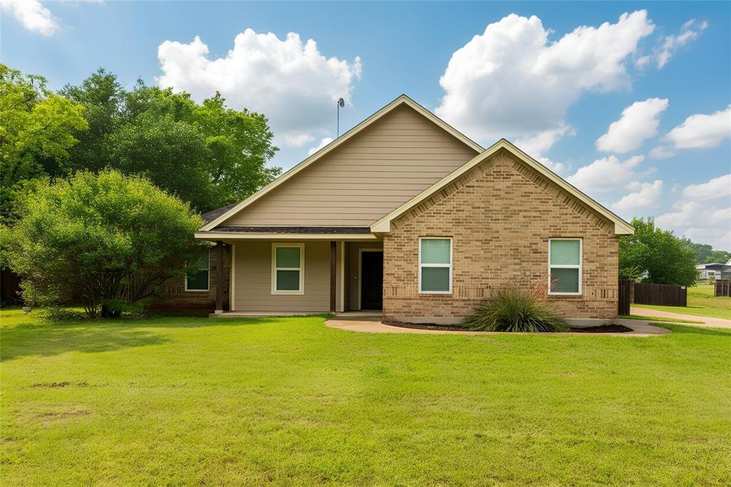 a front view of house with yard and green space