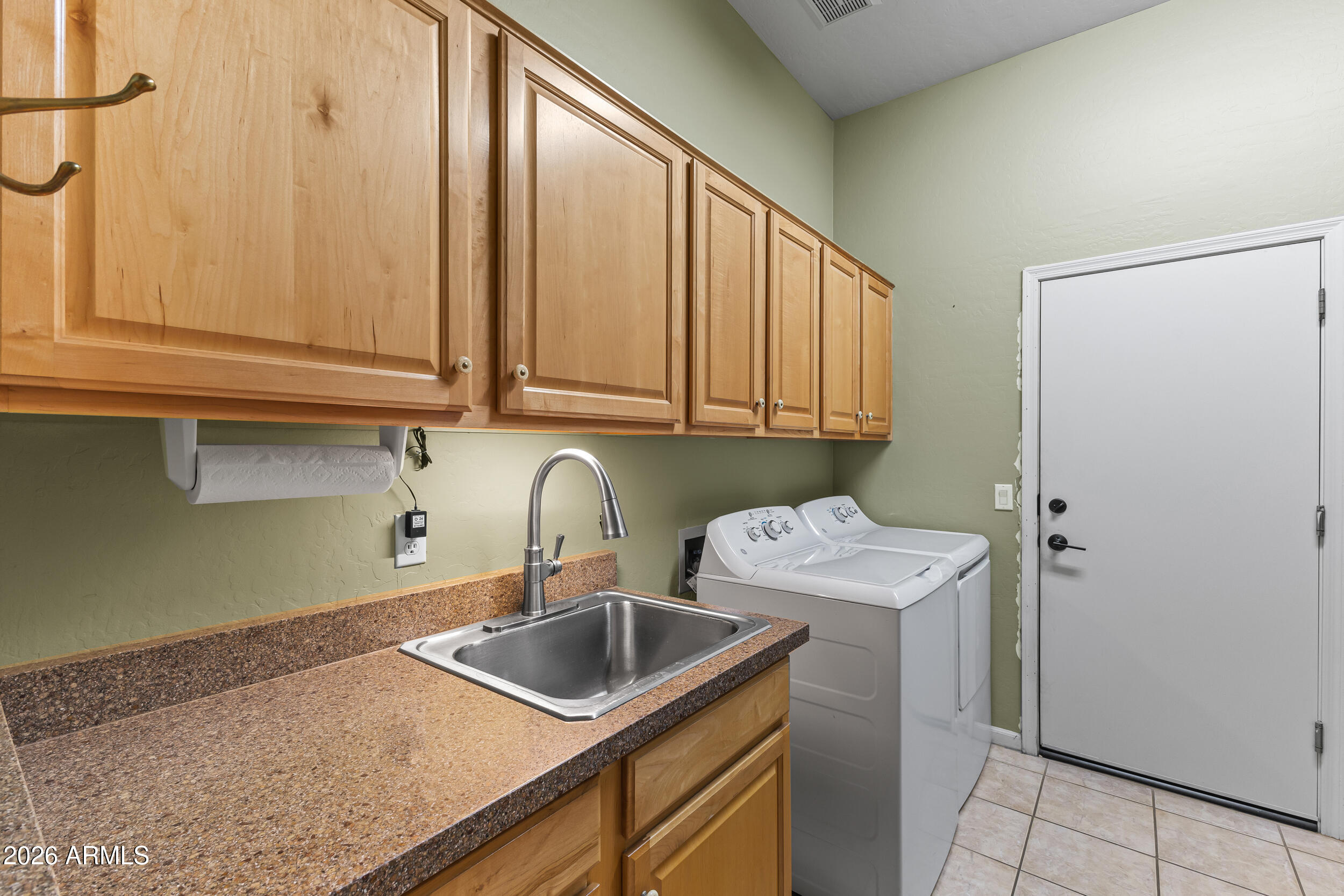 584 South Granite Street Gilbert, AZ 85296 - Photo 26 of 49 a kitchen with stainless steel appliances granite countertop a sink and cabinets