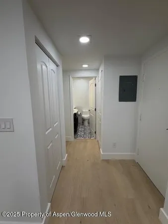 a view of a hallway and a livingroom with furniture
