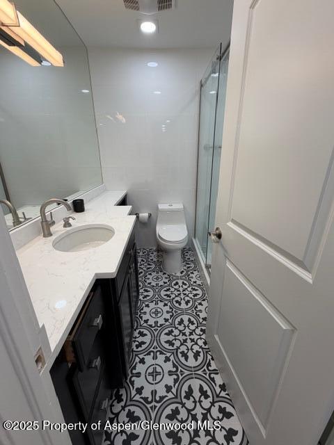 910 West Hallam Street, Unit 12 Aspen, CO 81611 - Photo 20 of 28 a bathroom with a sink a toilet a mirror and shower