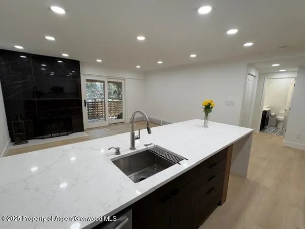 a kitchen with stainless steel appliances a sink and a refrigerator