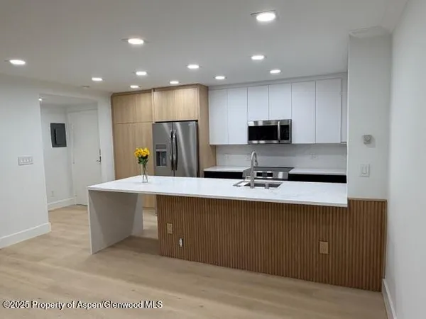 a view of kitchen with refrigerator stove microwave and cabinets