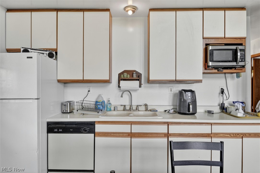 1526 Stevenson Road Ashtabula, OH 44004 - Photo 13 of 50 Kitchen featuring a white refrigerator, integrated dishwasher, and a double basin sink