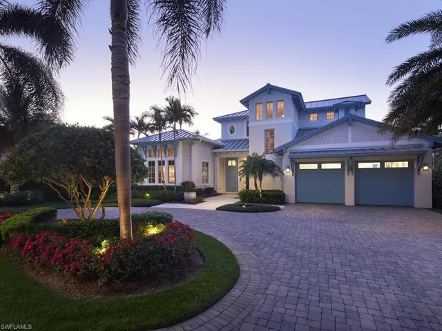 a front view of a house with yard and green space