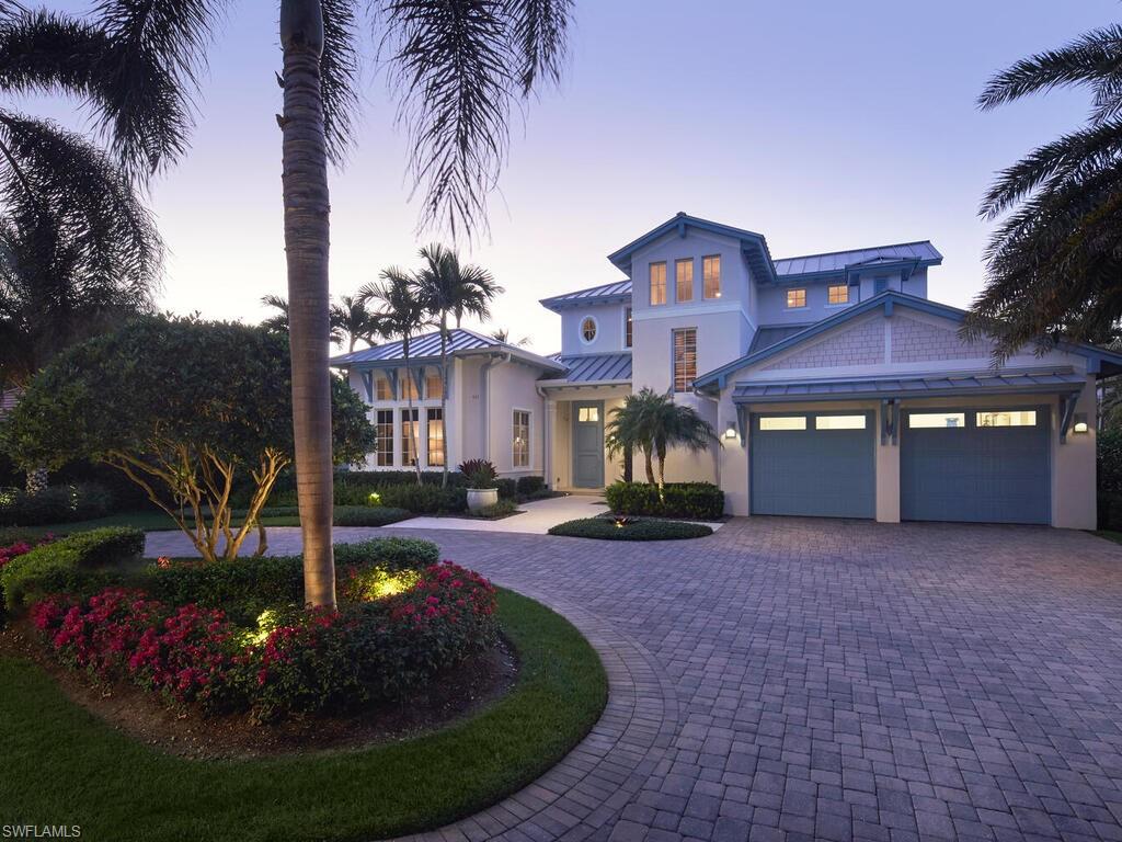 a front view of a house with yard and green space