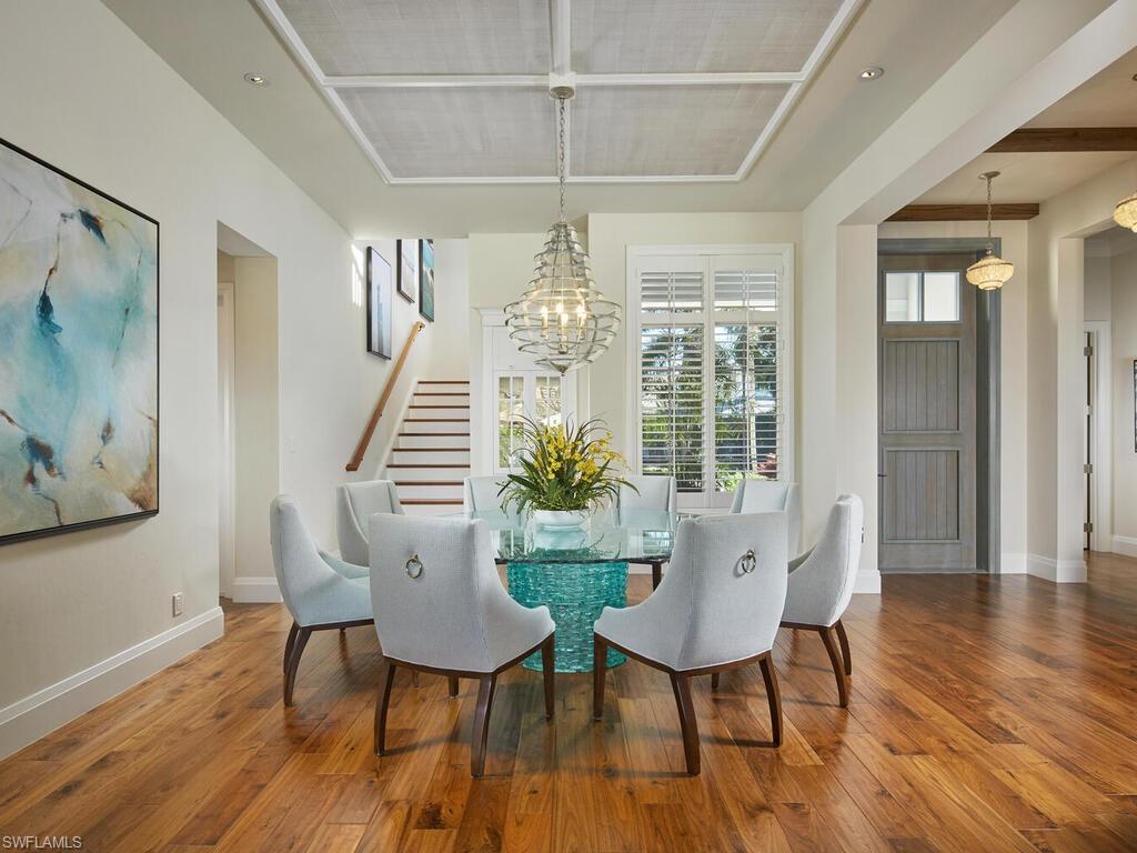 631 Broad Court North Naples, FL 34102 - Photo 11 of 23 a view of a dining room with furniture window and wooden floor