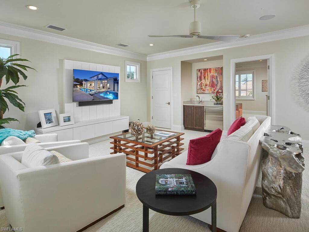 631 Broad Court North Naples, FL 34102 - Photo 17 of 23 a living room with furniture and a flat screen tv