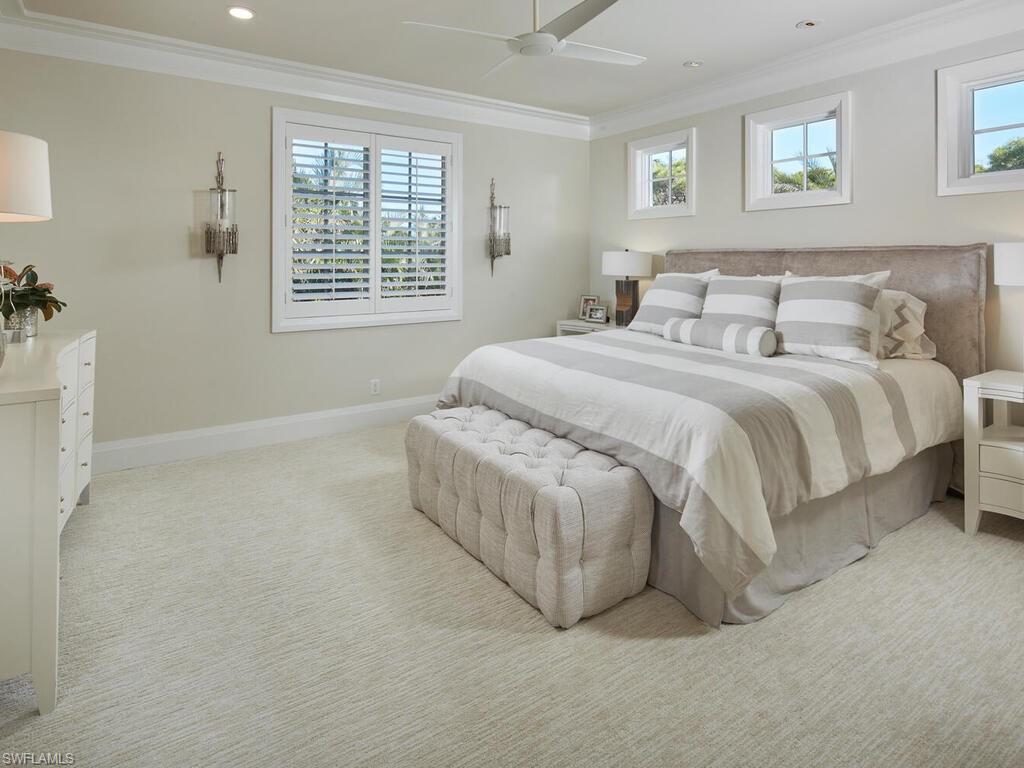 631 Broad Court North Naples, FL 34102 - Photo 19 of 23 a spacious bedroom with a bed and a window
