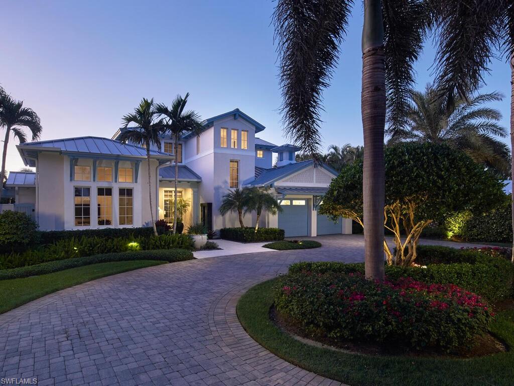 631 Broad Court North Naples, FL 34102 - Photo 2 of 23 a front view of a house with garden
