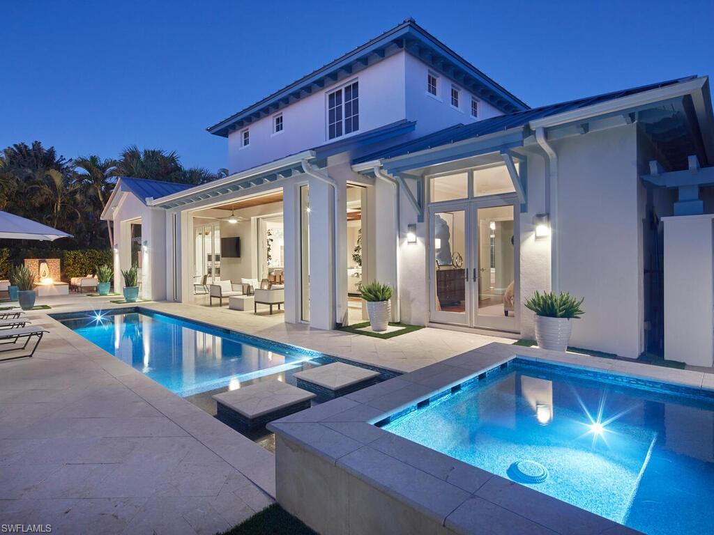 631 Broad Court North Naples, FL 34102 - Photo 5 of 23 a view of a patio with swimming pool table and chairs