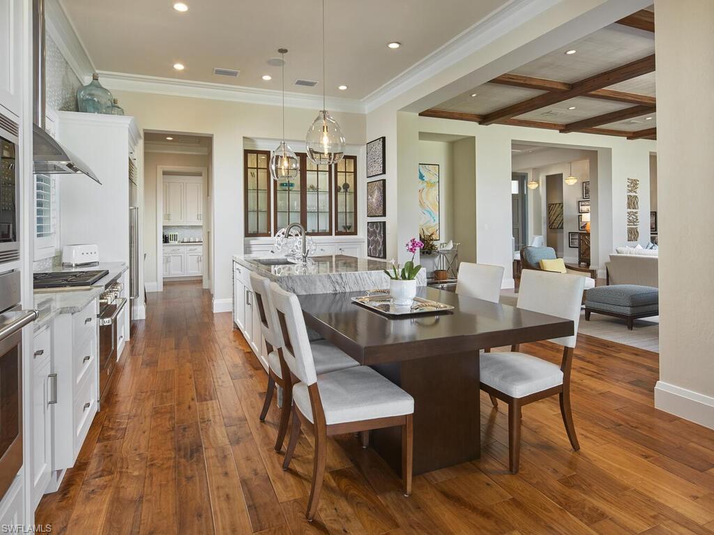 631 Broad Court North Naples, FL 34102 - Photo 8 of 23 a view of a dining room with furniture and wooden floor