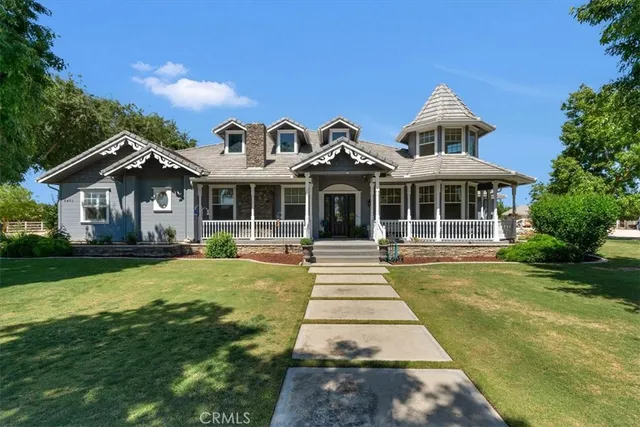 a front view of a house with yard and green space