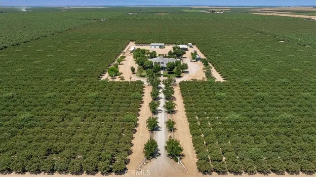 an aerial view of a house with a yard and lake view