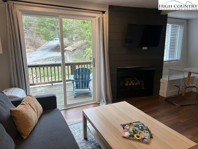 a view of a livingroom with furniture a flat screen tv and a fireplace