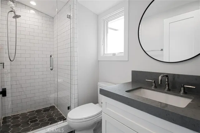 a bathroom with a sink toilet and a mirror