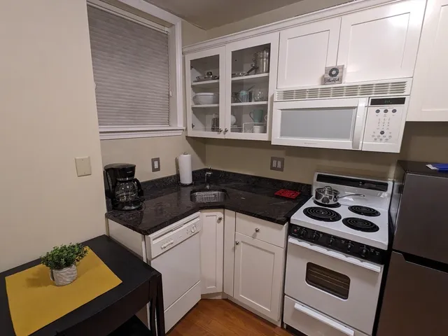 a kitchen with stainless steel appliances granite countertop a stove and a cabinets