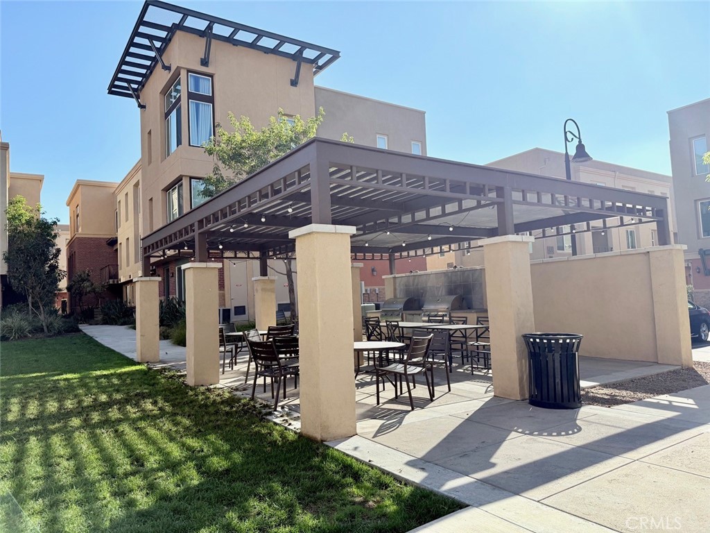 422 West Rte 66, Unit 87 Glendora, CA 91740 - Photo 12 of 35 a view of a patio with table and chairs and potted plants