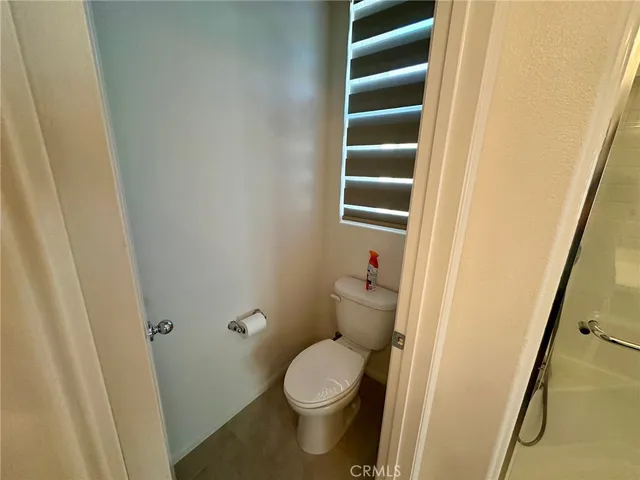 a bathroom with a toilet and a window