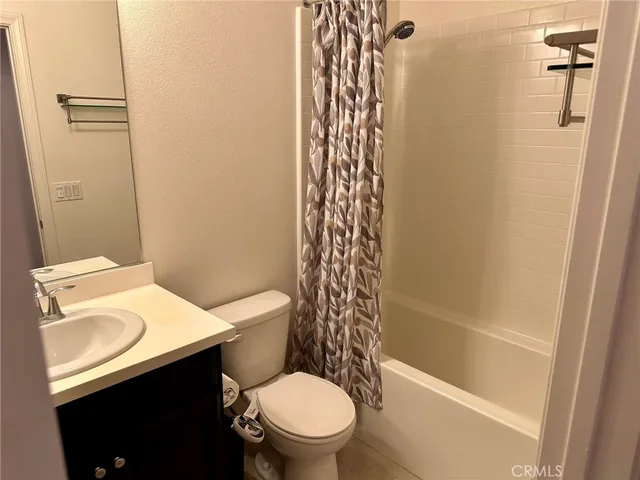 a white toilet sitting next to a bath tub