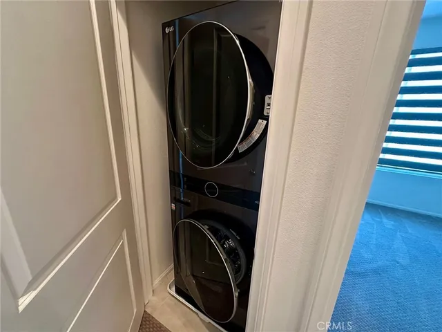 a view of a hallway with washer and dryer