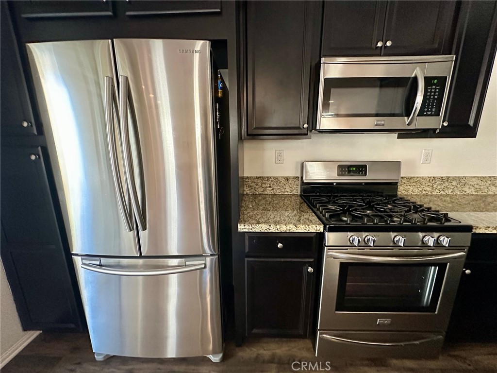422 West Rte 66, Unit 87 Glendora, CA 91740 - Photo 35 of 35 a kitchen with stainless steel appliances wooden floor sink and microwave