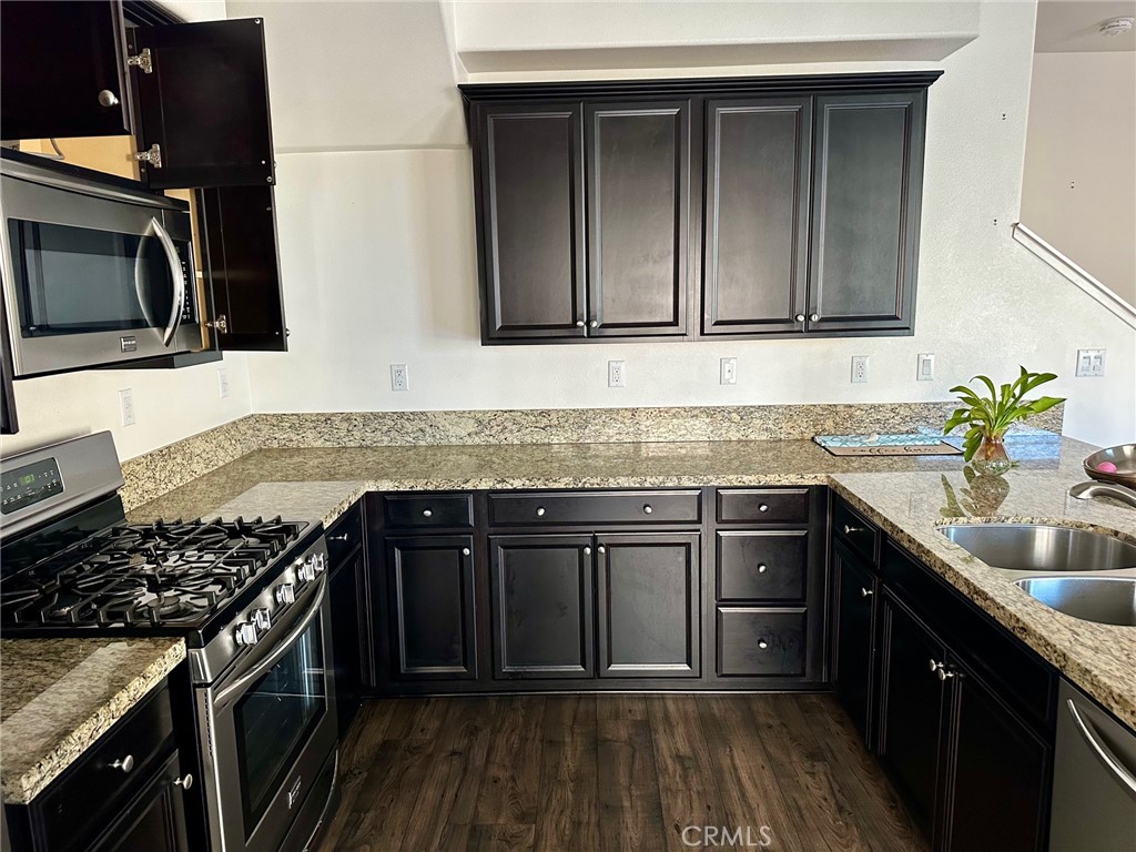 422 West Rte 66, Unit 87 Glendora, CA 91740 - Photo 5 of 35 a kitchen with stainless steel appliances granite countertop a sink stove and cabinets