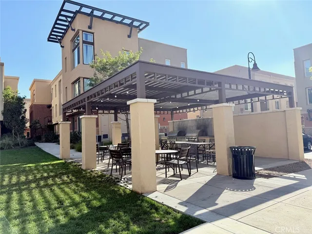 a view of a patio with table and chairs and potted plants