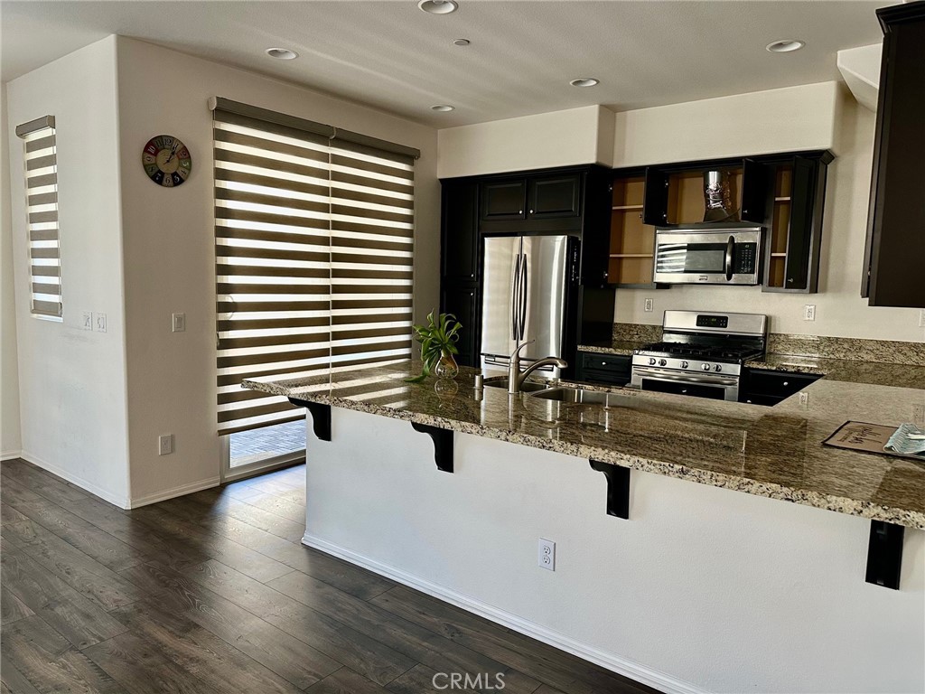 422 West Rte 66, Unit 87 Glendora, CA 91740 - Photo 7 of 35 a kitchen with stainless steel appliances a sink a stove and cabinets