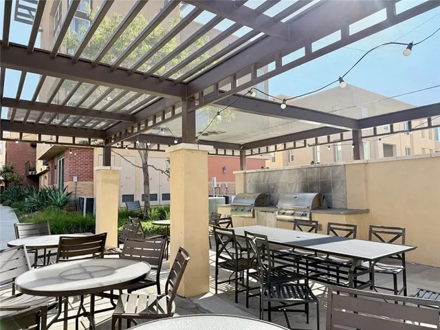 a view of a patio with a table and chairs under an umbrella