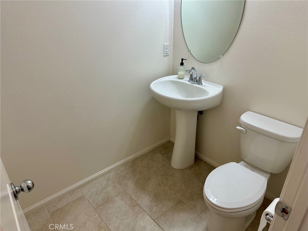 422 West Rte 66, Unit 87 Glendora, CA 91740 - Photo 10 of 35 a bathroom with a toilet sink and mirror