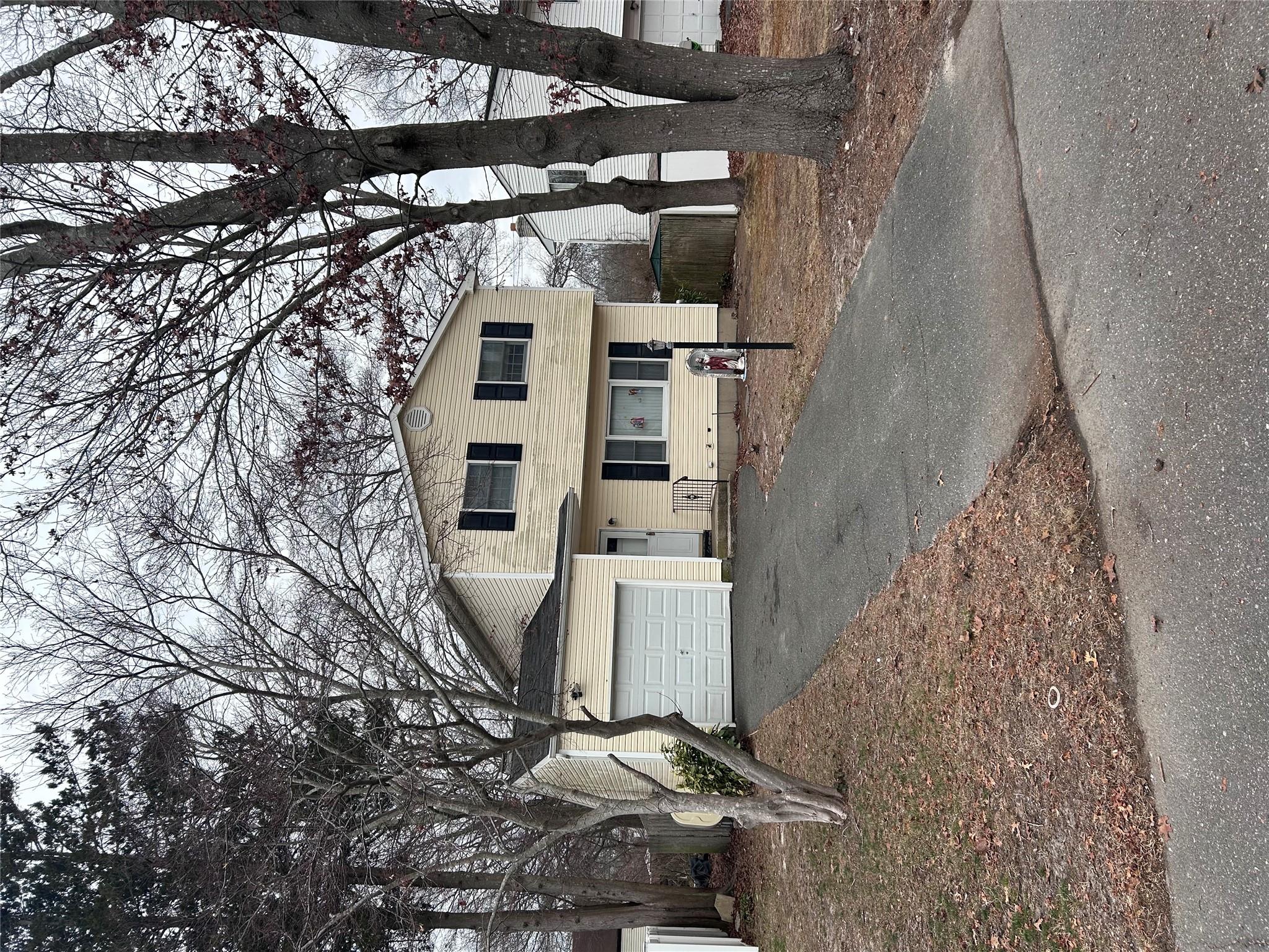 174 Concord Road Shirley, NY 11967 - Photo 1 of 1 Front facade with a garage