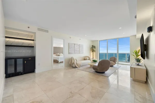 a bedroom with furniture and a flat screen tv