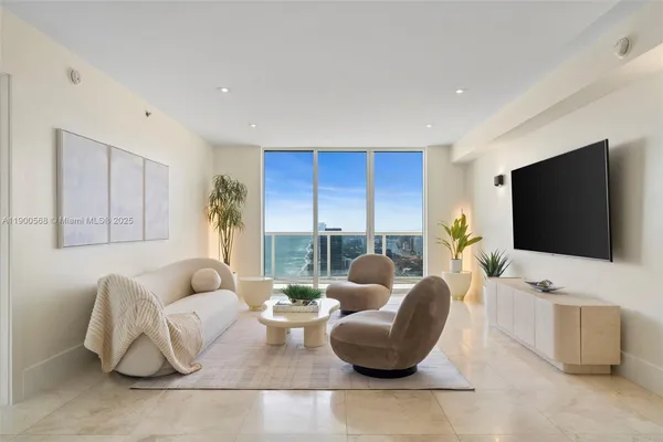 a living room with furniture and a flat screen tv