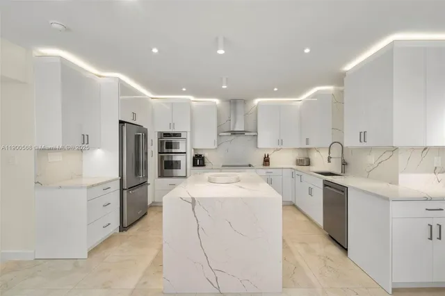 a kitchen with white cabinets and stainless steel appliances