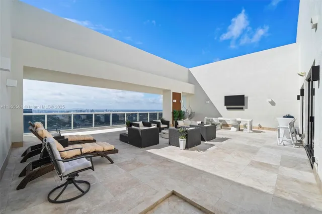 a view of a patio with dining table and chairs with wooden fence