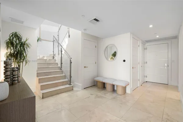 a view of entryway with stairs and a chandelier