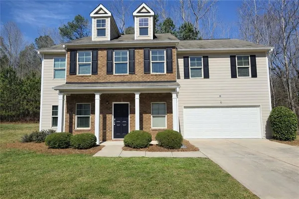 a front view of a house with a yard