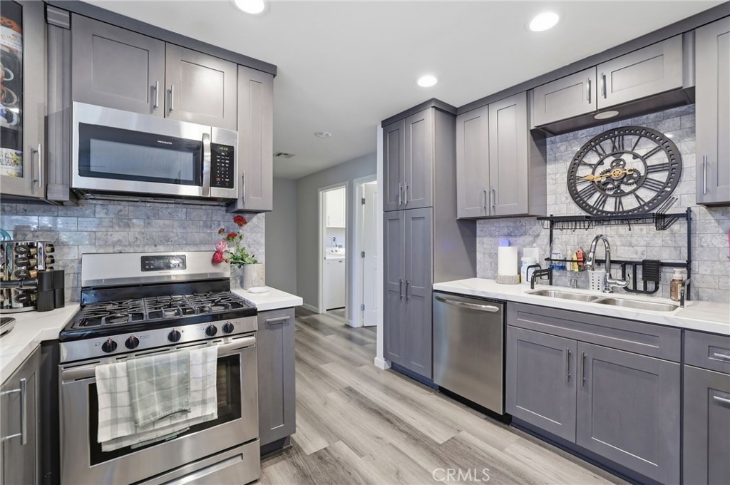 3370 Pachappa Hill Riverside, CA 92506 - Photo 11 of 36 a kitchen with stainless steel appliances a stove a sink and a microwave