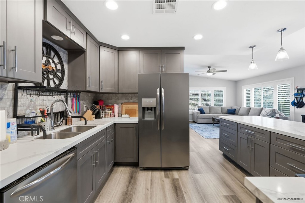 3370 Pachappa Hill Riverside, CA 92506 - Photo 12 of 36 a kitchen with kitchen island granite countertop a sink cabinets and stainless steel appliances