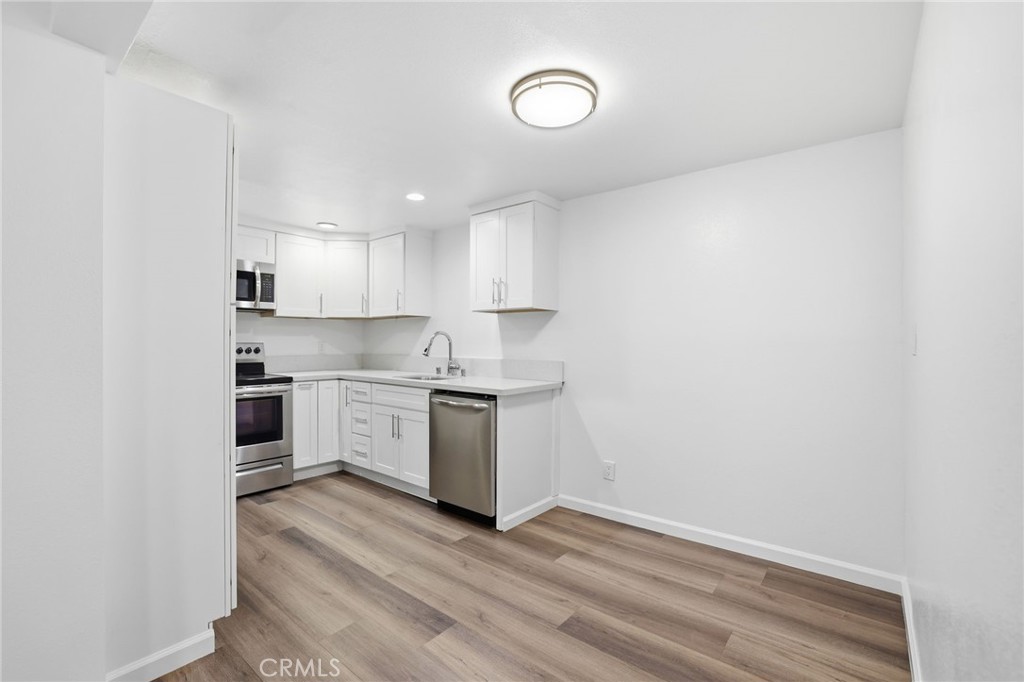 3370 Pachappa Hill Riverside, CA 92506 - Photo 24 of 36 a kitchen with granite countertop white cabinets and white appliances