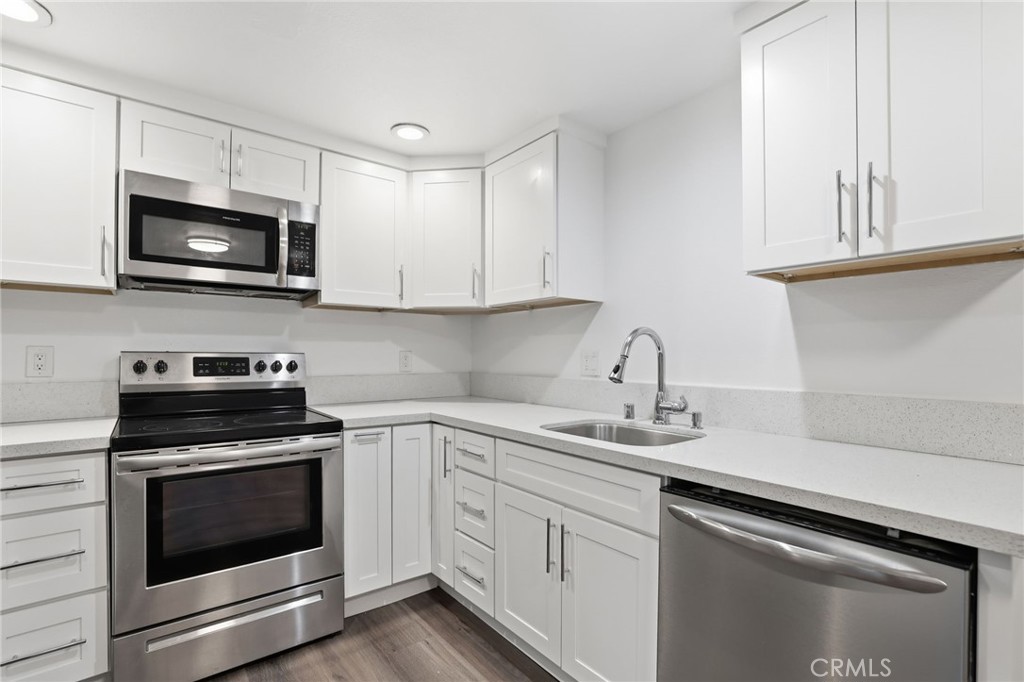 3370 Pachappa Hill Riverside, CA 92506 - Photo 26 of 36 a kitchen with stainless steel appliances granite countertop grey cabinets a stove a sink and dishwasher