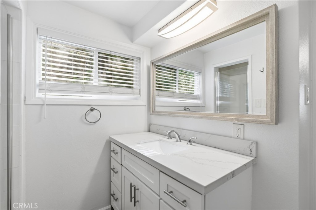 3370 Pachappa Hill Riverside, CA 92506 - Photo 31 of 36 a bathroom with a sink vanity and a mirror