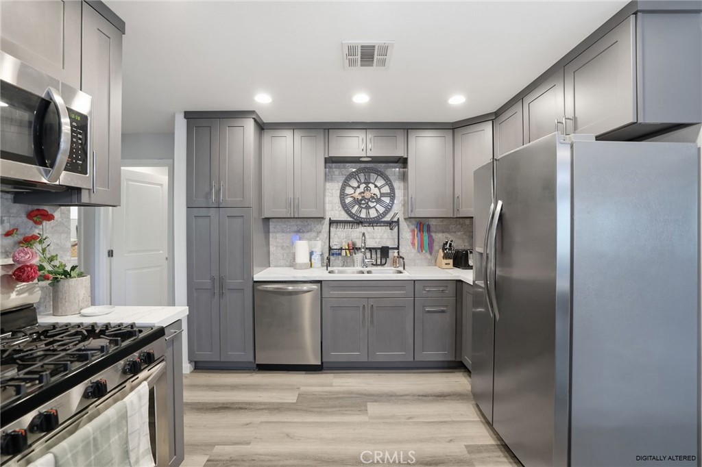 3370 Pachappa Hill Riverside, CA 92506 - Photo 10 of 36 a kitchen with stainless steel appliances granite countertop a refrigerator and a stove
