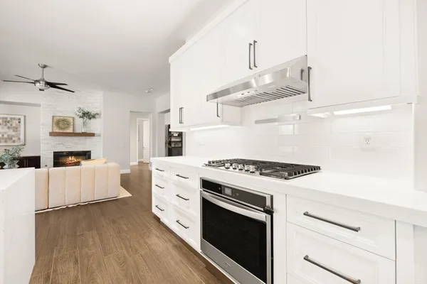 a kitchen with cabinets and wooden floor