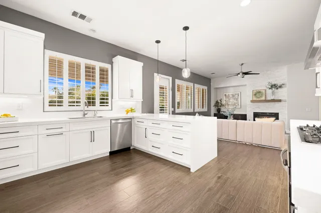 a large white kitchen with cabinets
