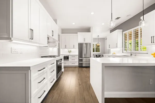a kitchen with white cabinets and white appliances
