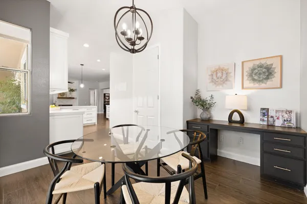 a view of a dining room with furniture and wooden floor