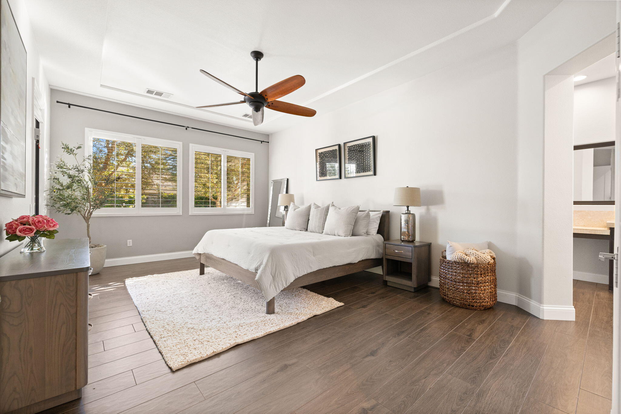 48864 Pear Street Indio, CA 92201 - Photo 20 of 46 a spacious bedroom with a large bed and a chandelier