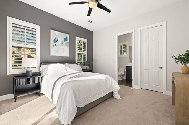 a bedroom with a bed and painting on the wall